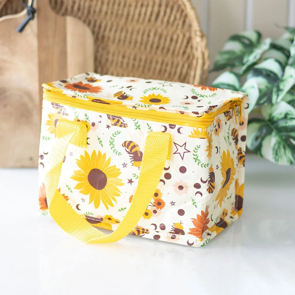 Insulated lunch bag with sunflowers, bees, pentagrams, and moon phases on a yellow background made from recycled plastic