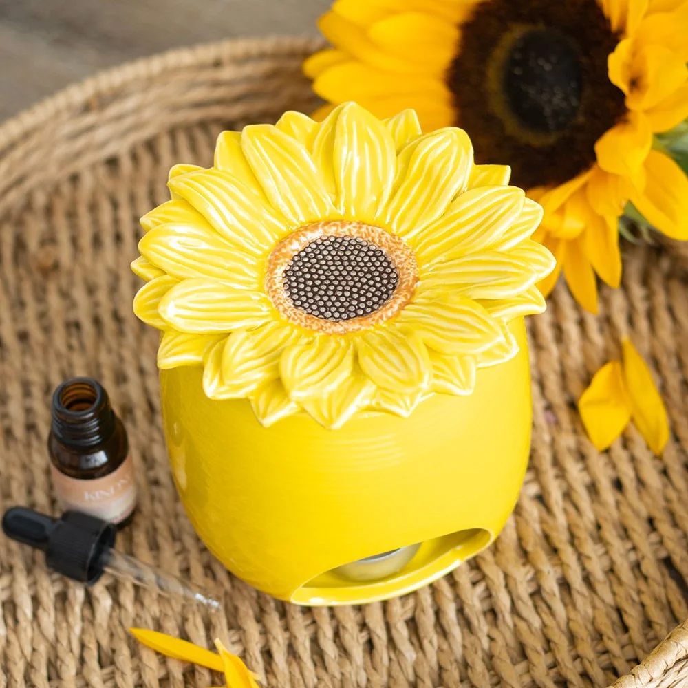 Yellow ceramic oil burner with sunflower design, featuring a bowl for wax melts and space for a tealight candle underneath