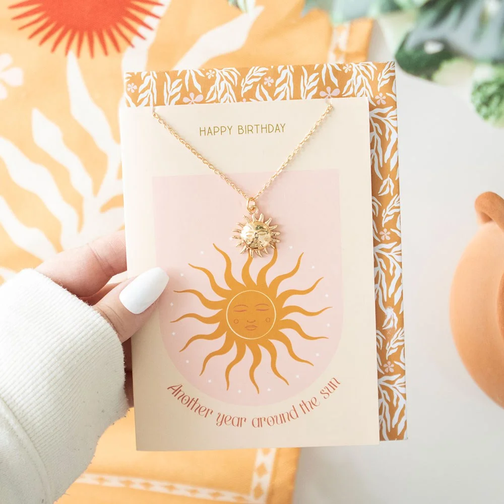 Sun necklace with sleek sun pendant on birthday card reading "Another Year Around the Sun" and "Happy Birthday" text