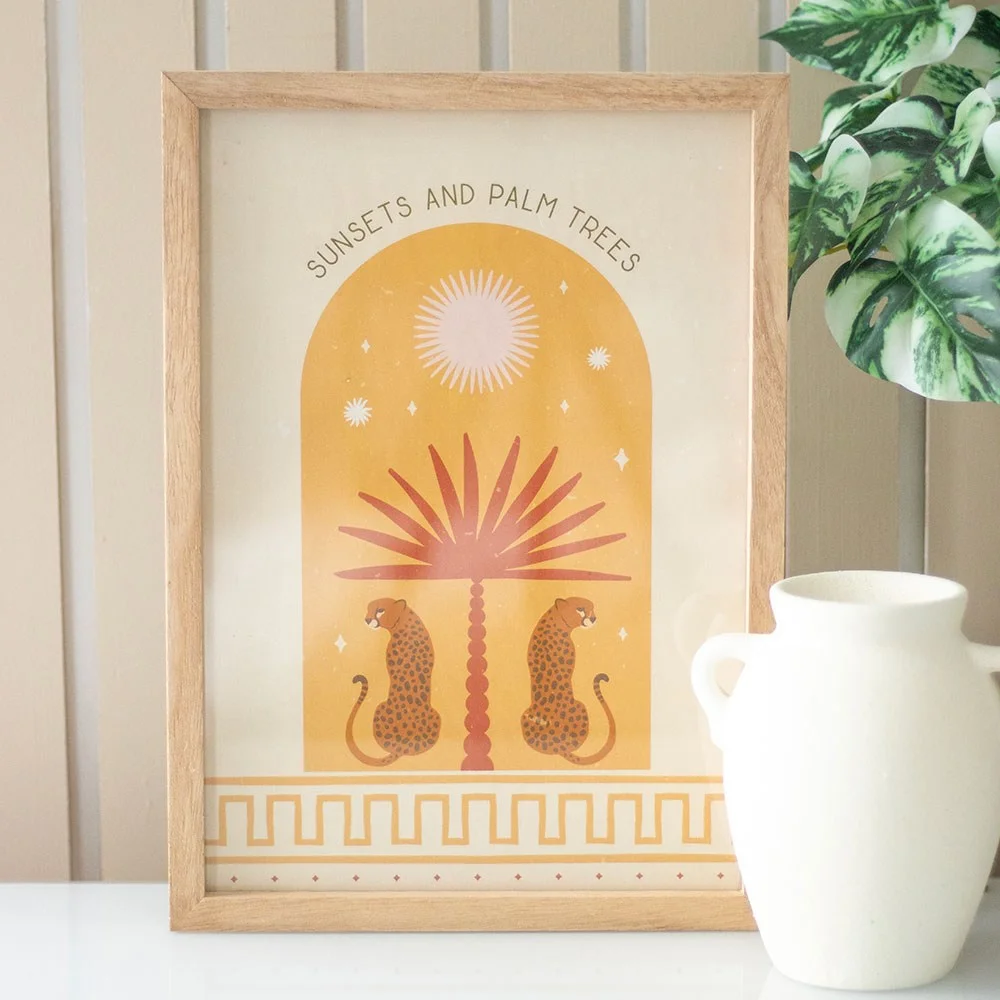 Leopard palm wall art showing two leopards lounging under a palm tree with the text Sunsets and Palm Trees