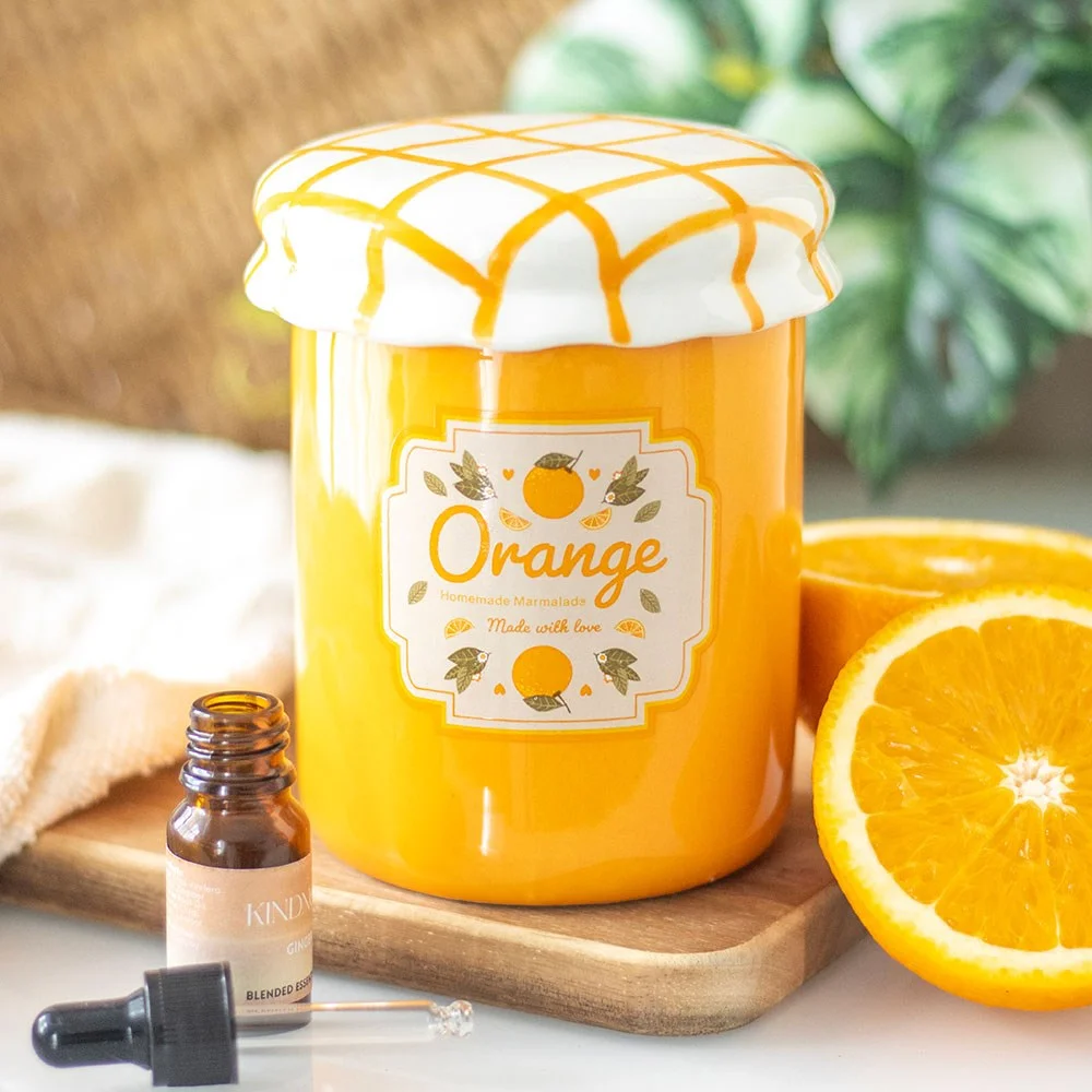 Orange marmalade oil burner shaped like a vintage jam jar with orange finish and fruit label on the side