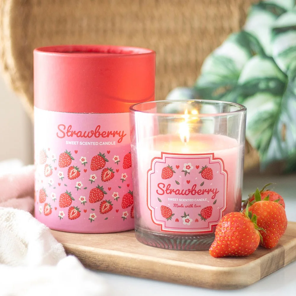Strawberry scented candle in glass holder with floral and strawberry print, wooden lid, and matching gift box