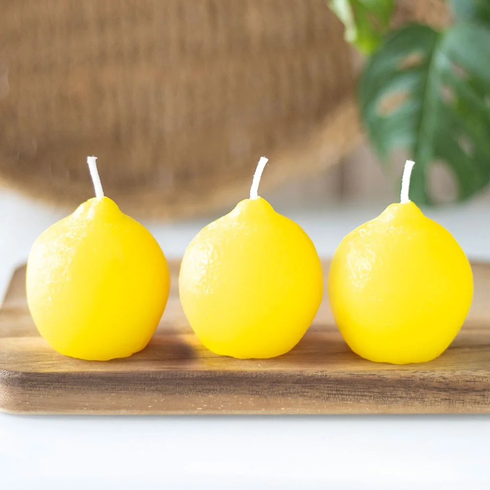 Set of 3 unscented lemon shaped candles in bright yellow, designed to add colourful decor accents at home