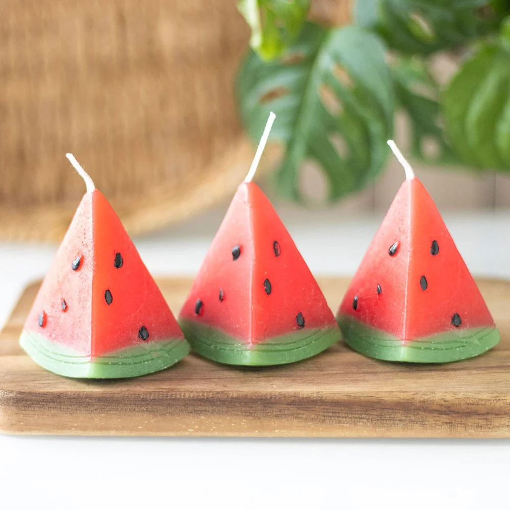 Set of 3 unscented watermelon shaped candles in red and green, designed to look like watermelon slices