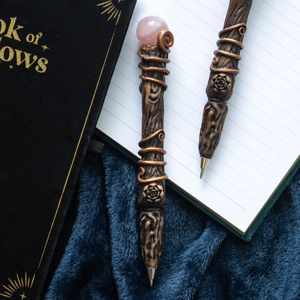Rose quartz wand pen with crystal tip and magic wand design, displayed with star and moon phase gift box