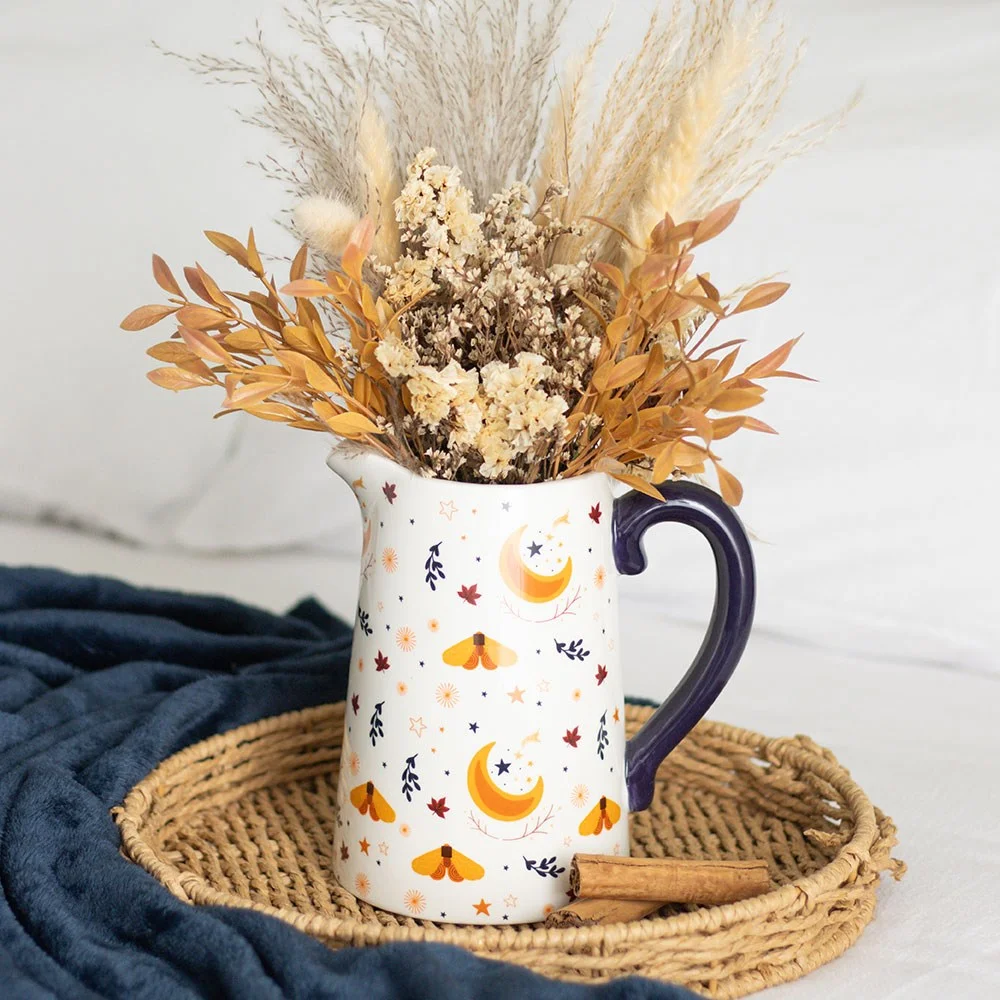 Ivory ceramic flower jug with autumn harvest moon, leaf design, and golden accents on a white background