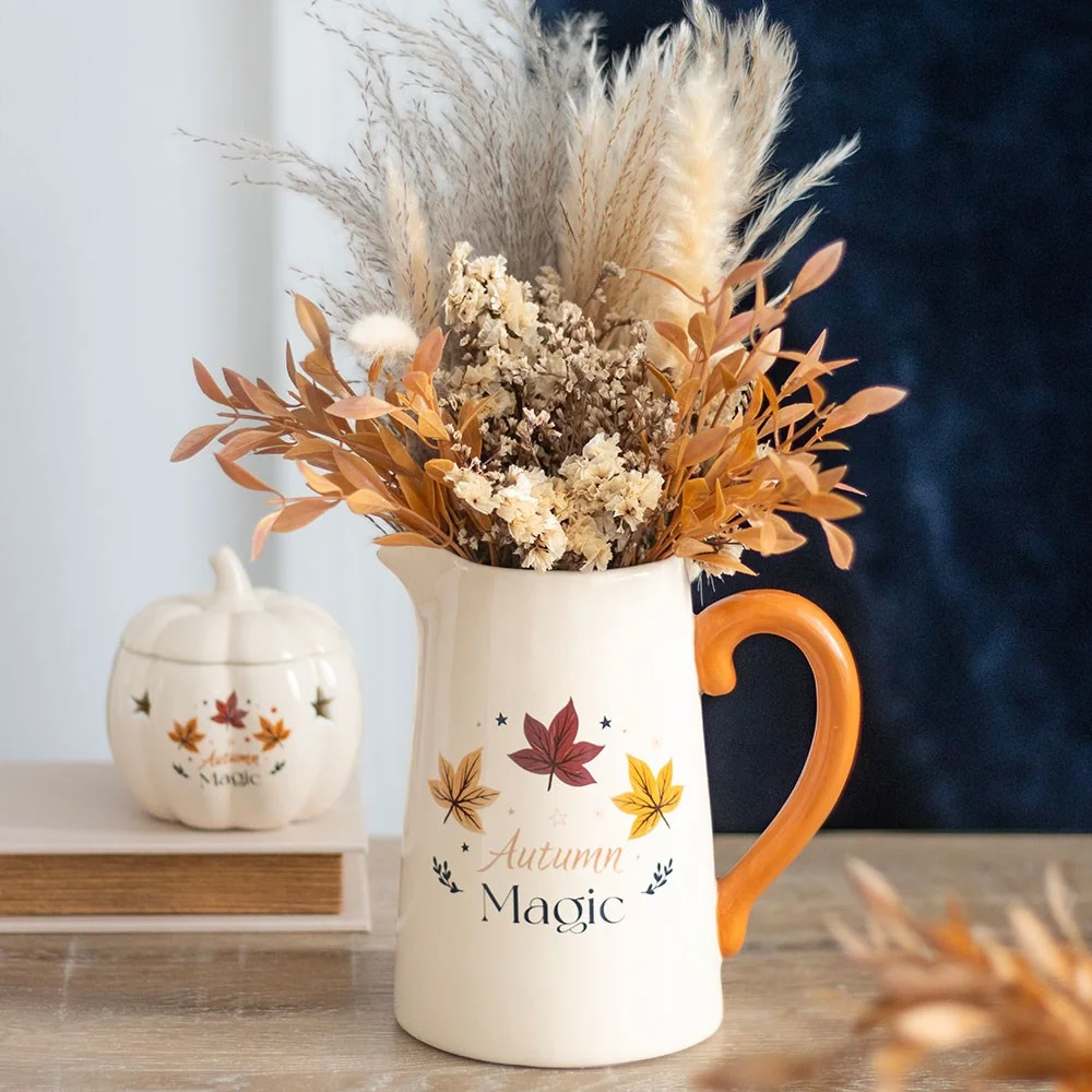 Creamy beige ceramic flower jug with a simple design, perfect for autumn floral arrangements on a white background