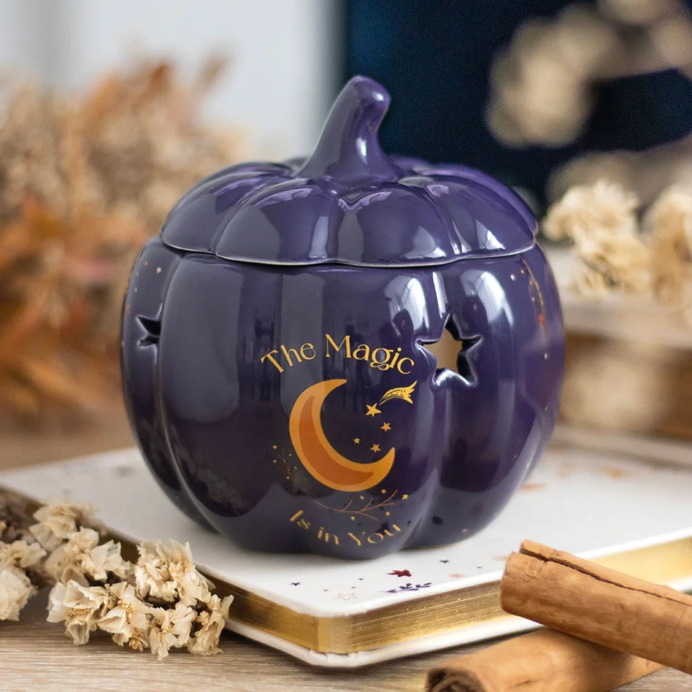 Midnight-blue ceramic pumpkin oil burner with golden stars and crescent moon design for autumn decor and scents