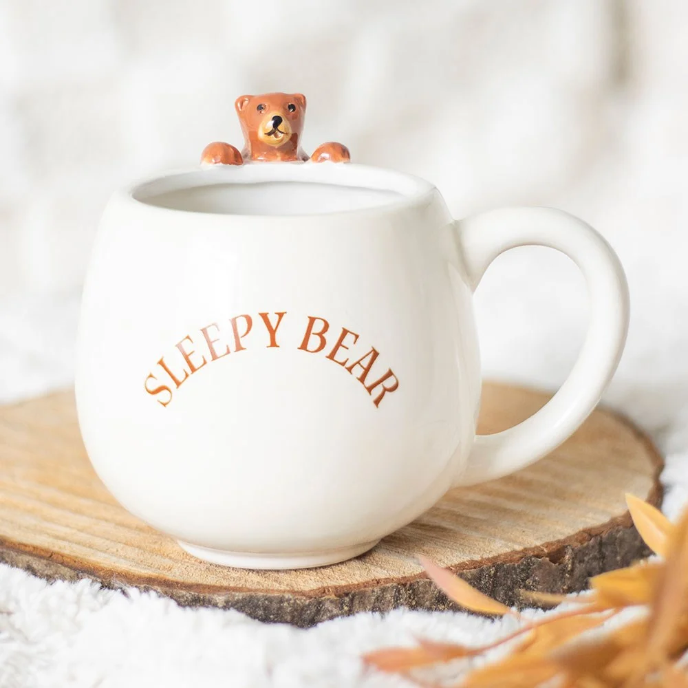 White rounded ceramic bear mug with Sleepy Bear text and a 3D bear figure hanging on the side, handwash only