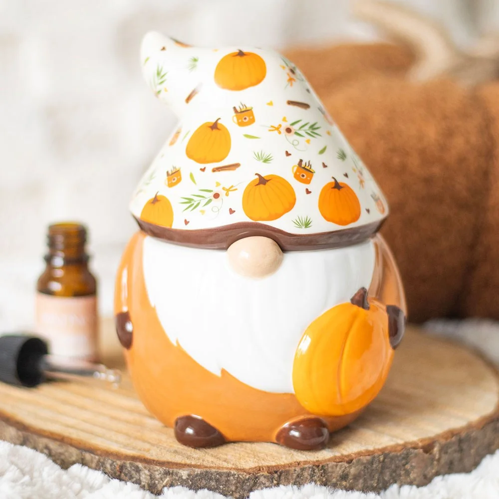 Autumn oil burner shaped like a gonk with pumpkin hat and heart cut-out, glowing warm light for cosy nights in