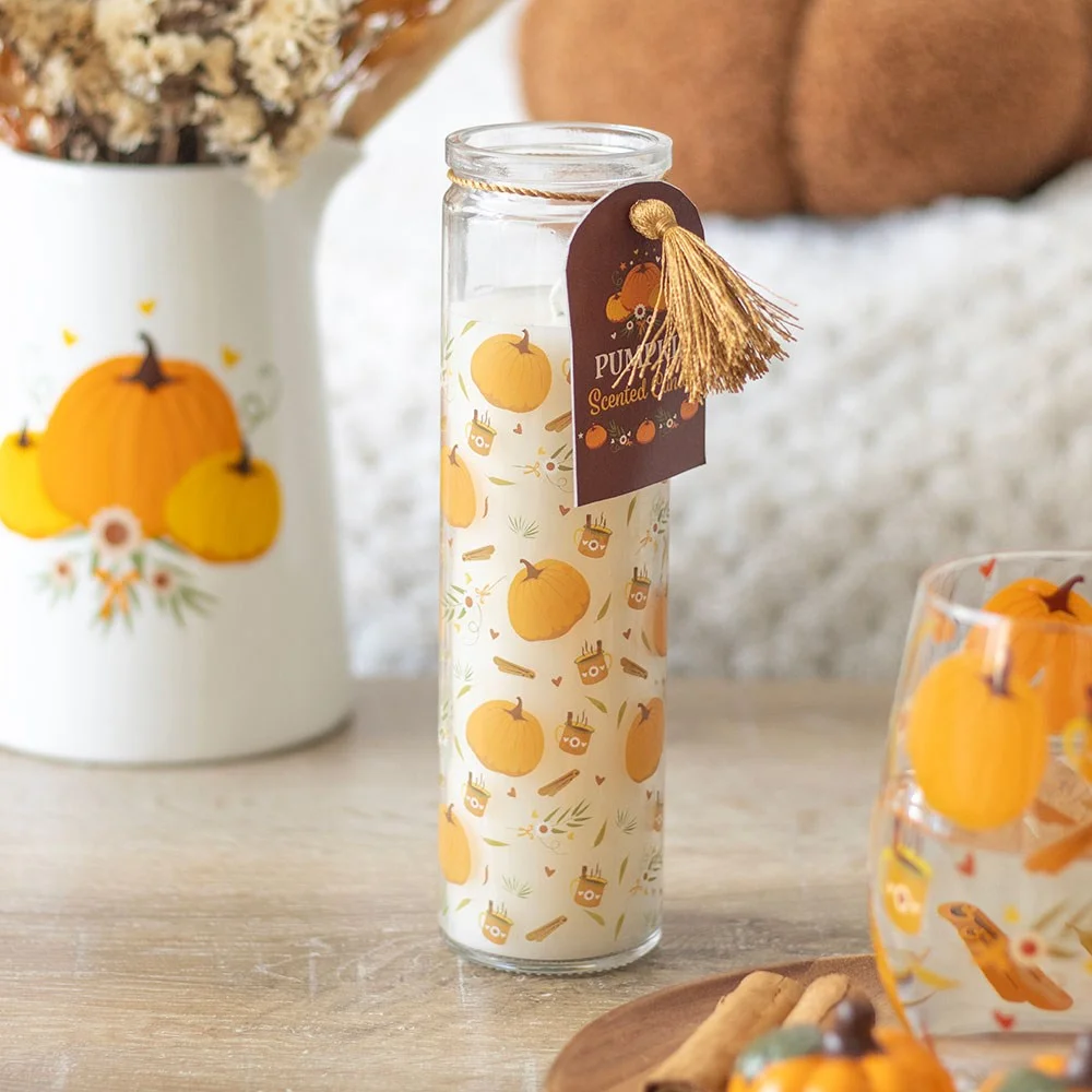 Tube candle with autumnal pumpkin design, labelled pumpkin scented candle, 50-hour burn time, inspired by prayer candles