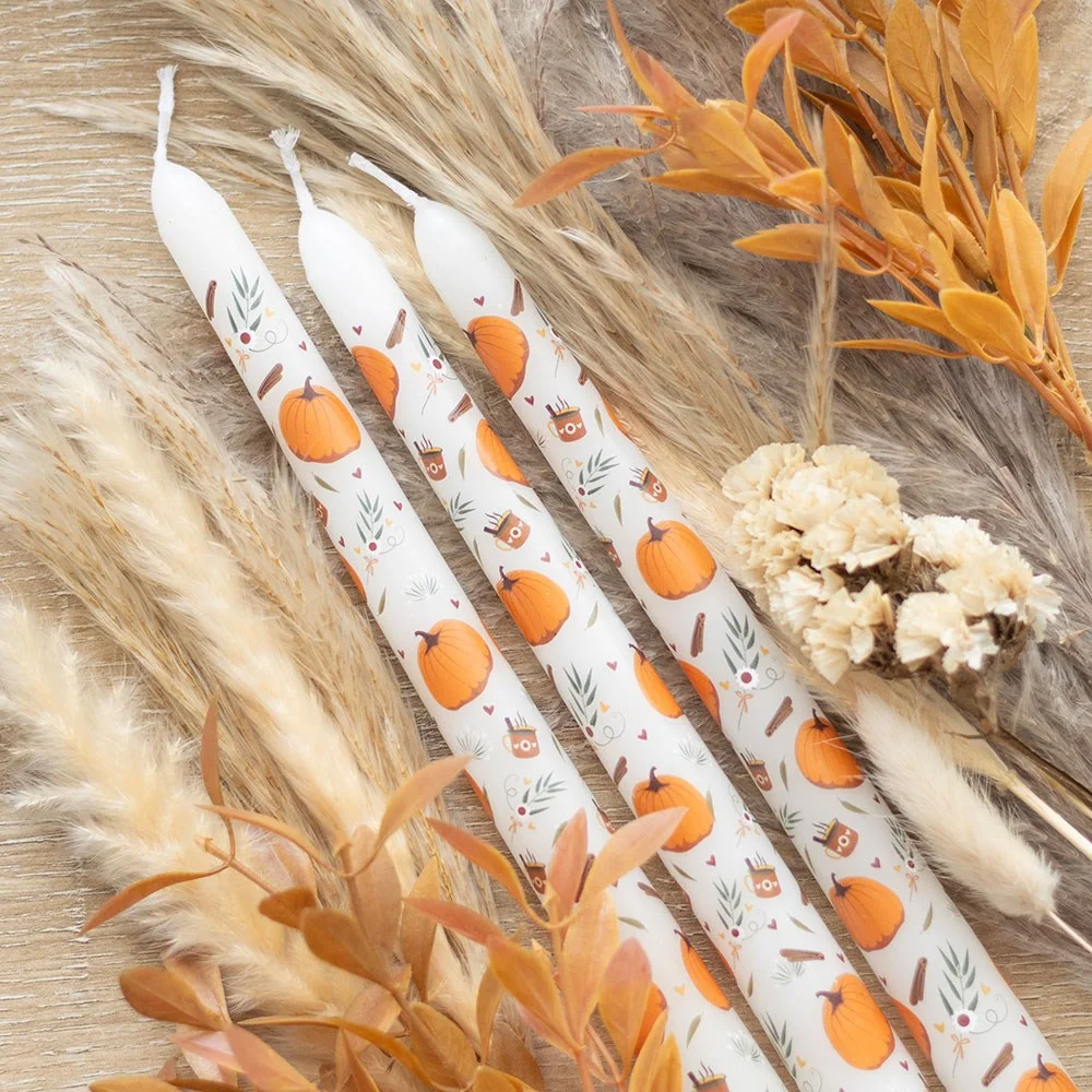 Set of 3 orange pumpkin taper candles with autumnal print, ideal for seasonal home decor and gatherings