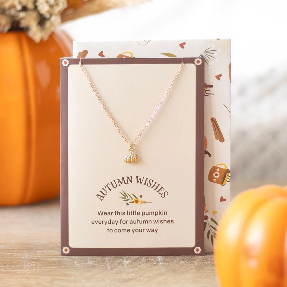 Gold-toned pumpkin necklace displayed on an autumn-themed greeting card with matching envelope, perfect pumpkin necklace gift