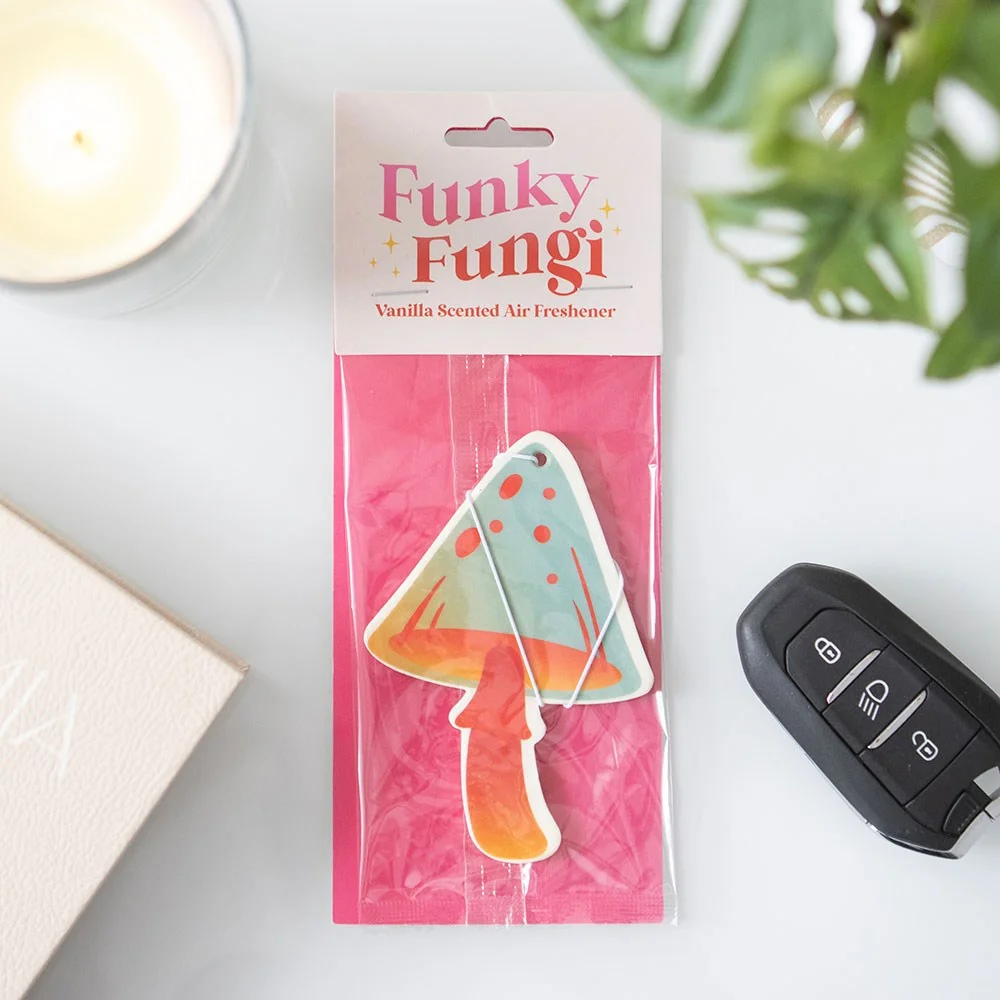 Mushroom-shaped vanilla air freshener hanging in car interior, designed to fill space with groovy vanilla scent