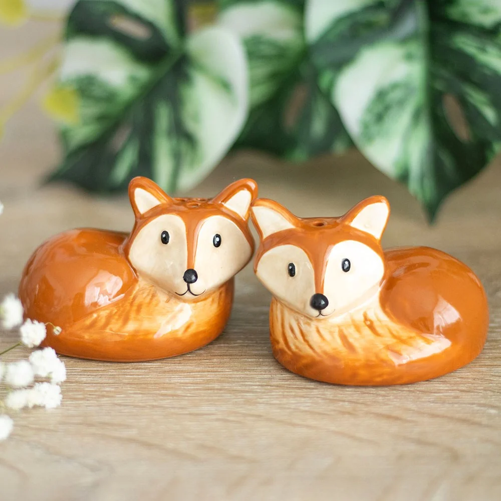 Set of two ceramic fox salt and pepper shakers with woodland charm, playful design for dining table.