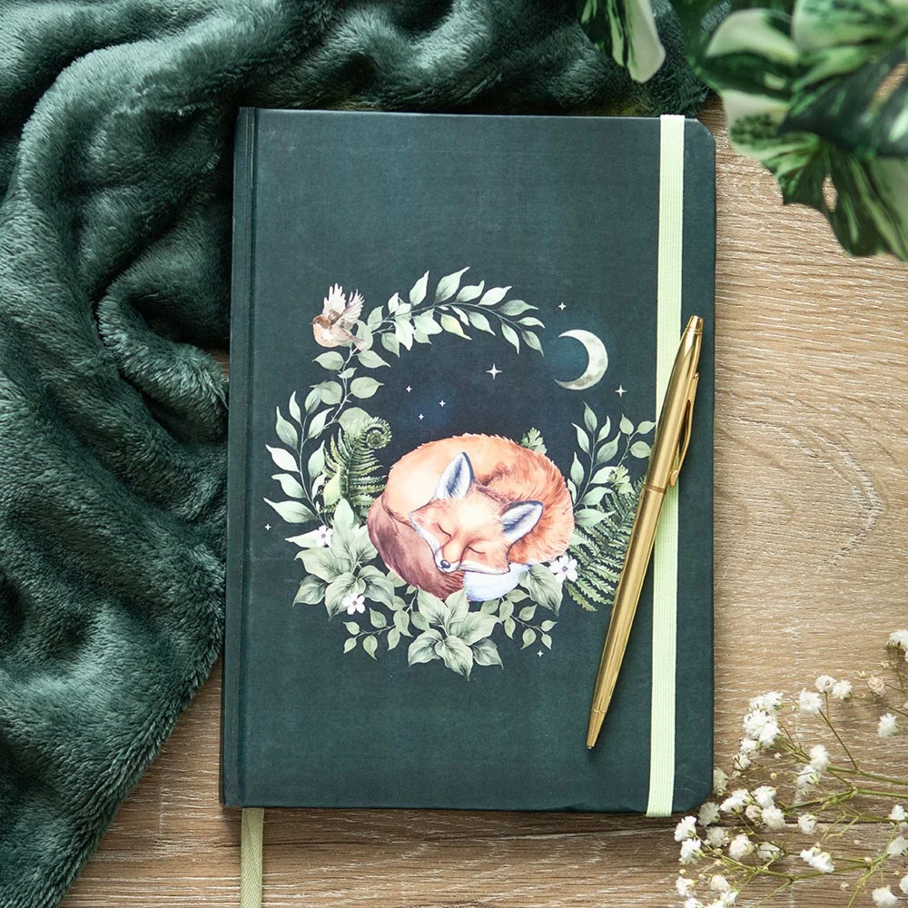 A5 notebook with green cover featuring a peaceful sleeping fox illustration and 200 lined pages inside
