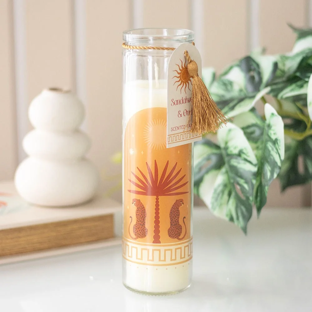 Glass tube candle with abstract leopard design, labelled Sandalwood oud candle, on white background