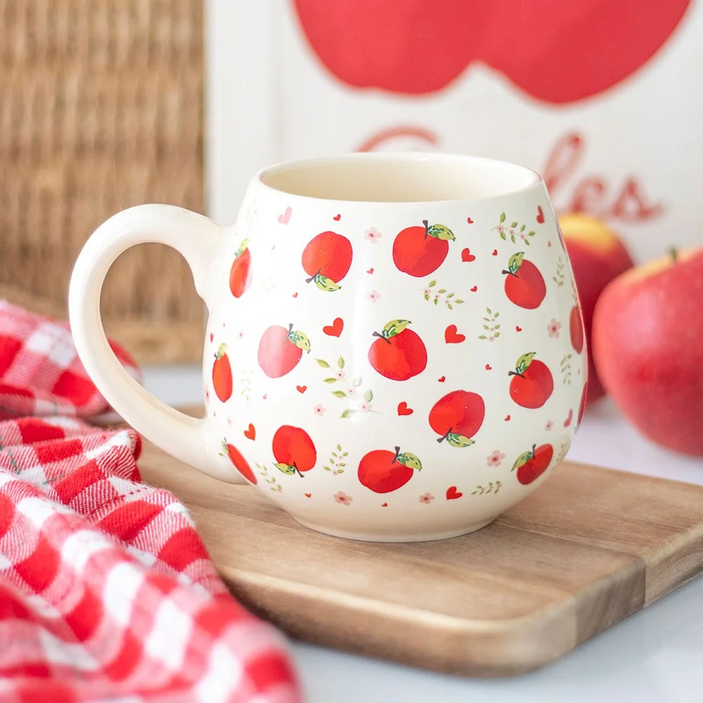 White ceramic apple print mug with rounded shape, holding 550ml, ideal for cosy home use or teacher gifts