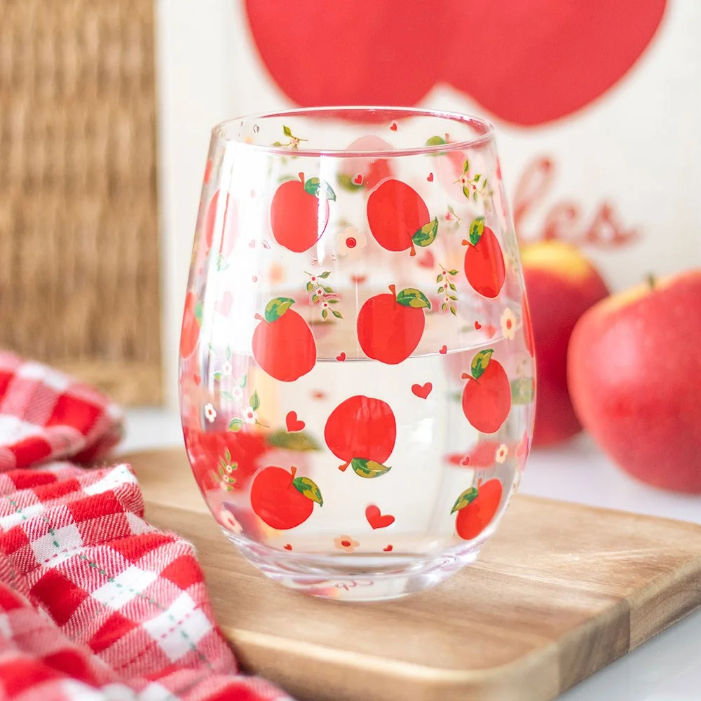 Clear stemless apple glass with vibrant red apple print, 350ml capacity, ideal for juice or cider at home