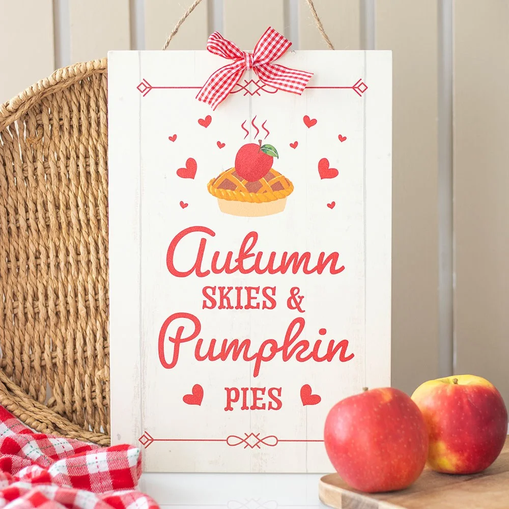 Decorative autumn hanging sign with "Autumn Skies & Pumpkin Pies" text in warm seasonal colors