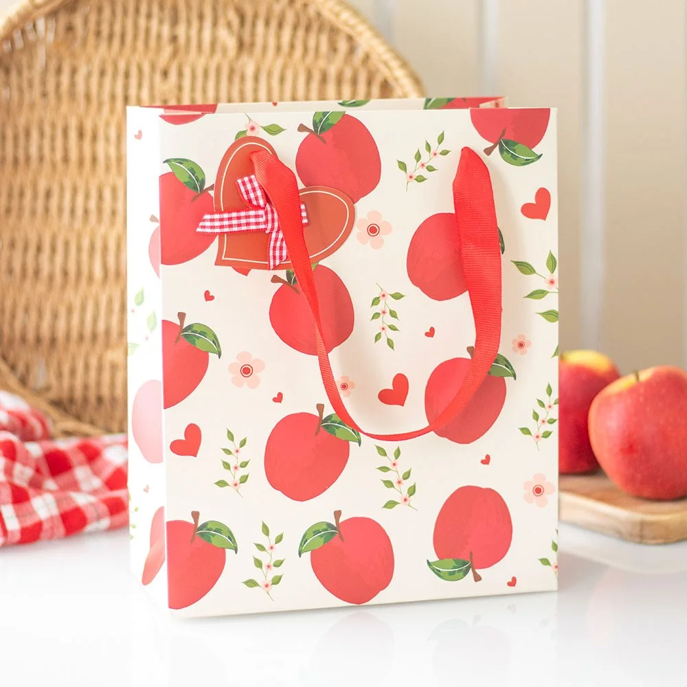 Medium apple print gift bag with red apples on white background, 23cm tall, paper gift bag for birthdays and gifts