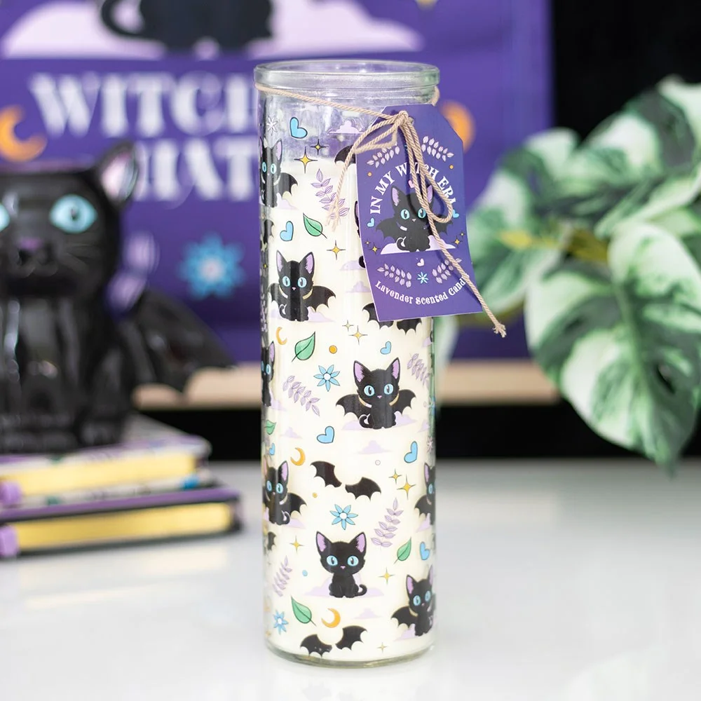 Lavender scented candle with black cat print on white tube, standing upright against plain background