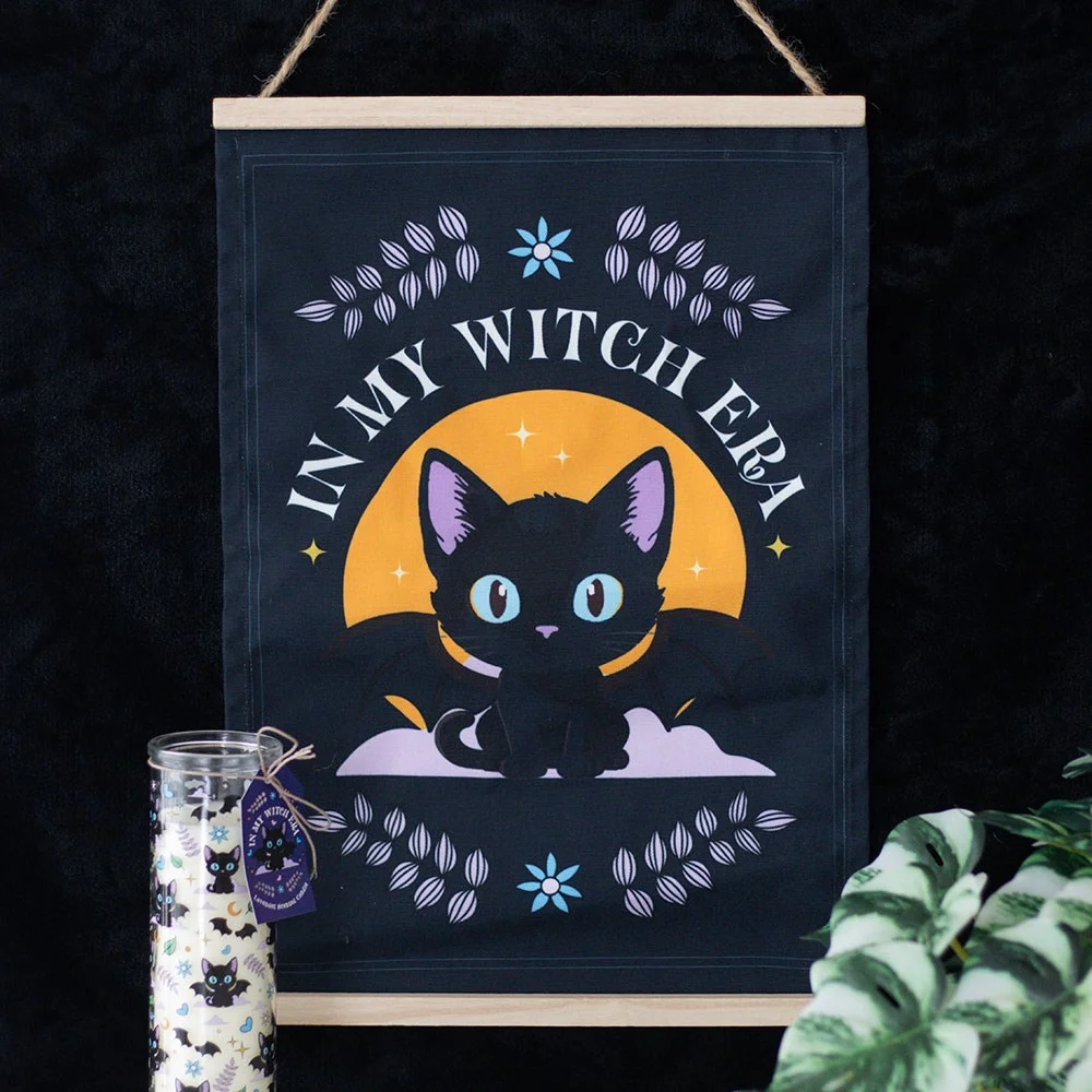 Black cat with bat wings and phrase In My Witch Era on fabric witch cat wall hanging for spooky decor