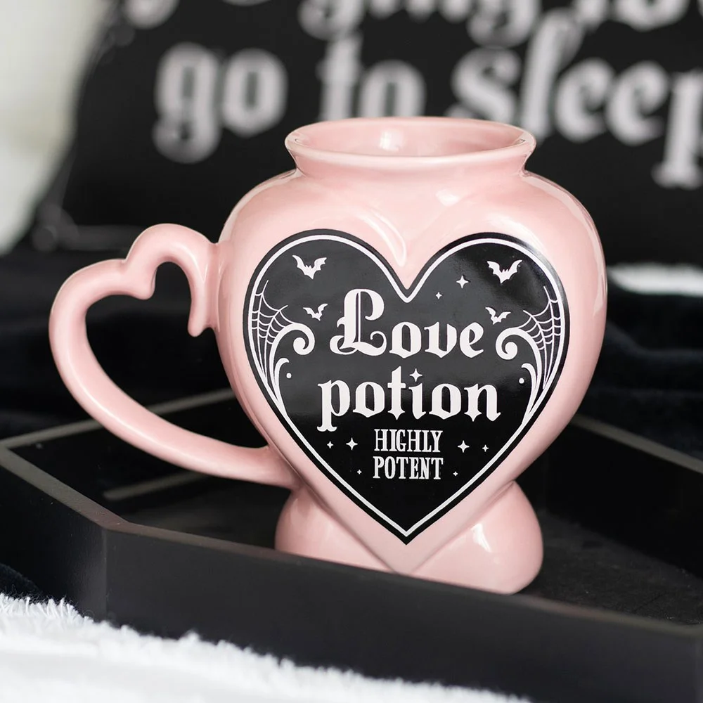 Ceramic love potion mug shaped like a pink and gothic potion bottle, 350ml capacity, handwash only.