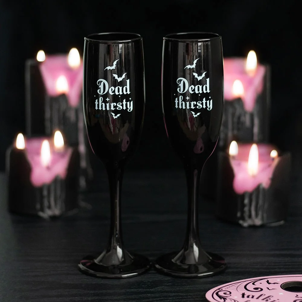 Set of 2 sleek black Dead Thirsty champagne flutes with gothic design, each holding 300ml, ideal for spooky celebrations