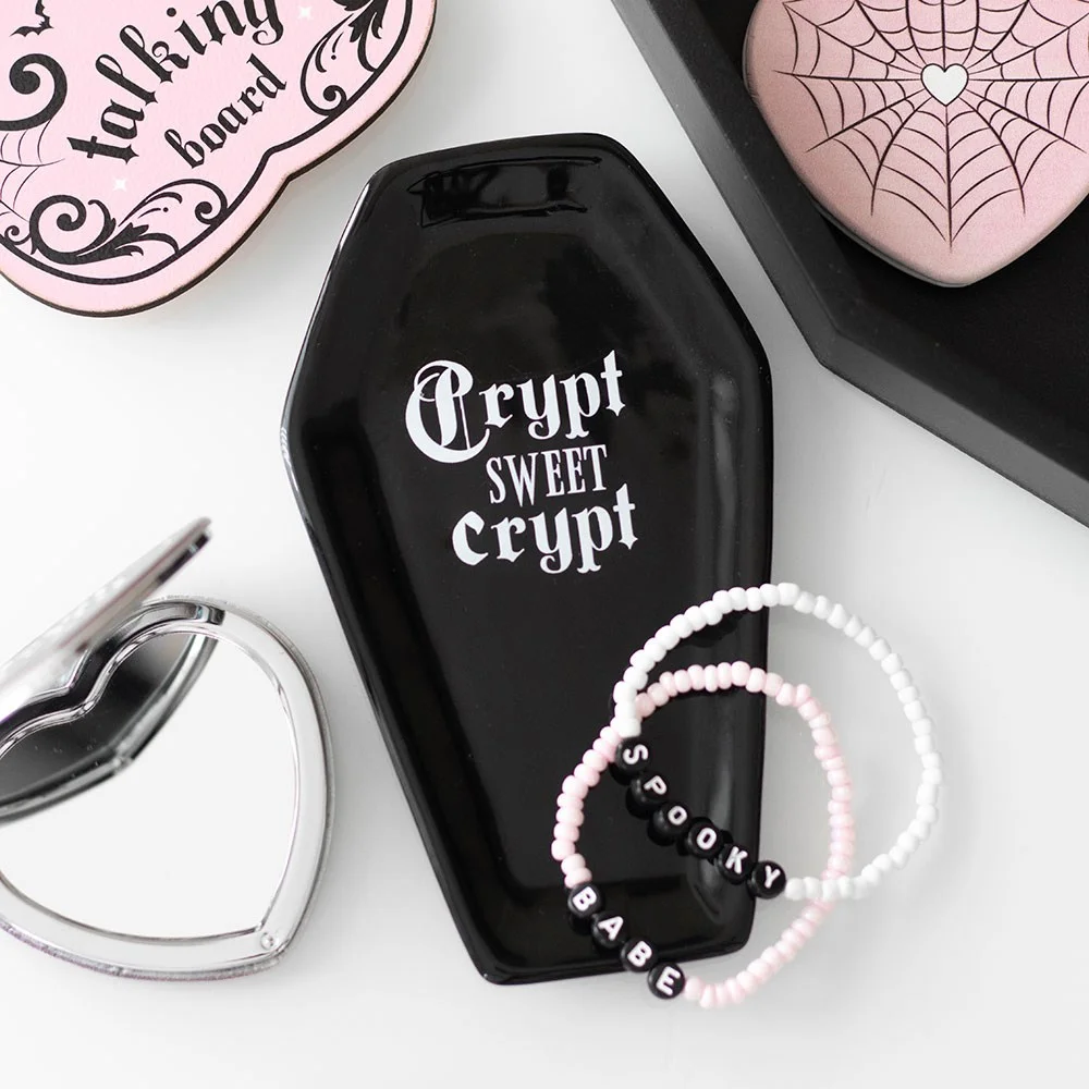 Ceramic coffin trinket tray with black gothic design and "Crypt Sweet Crypt" slogan, holding small accessories