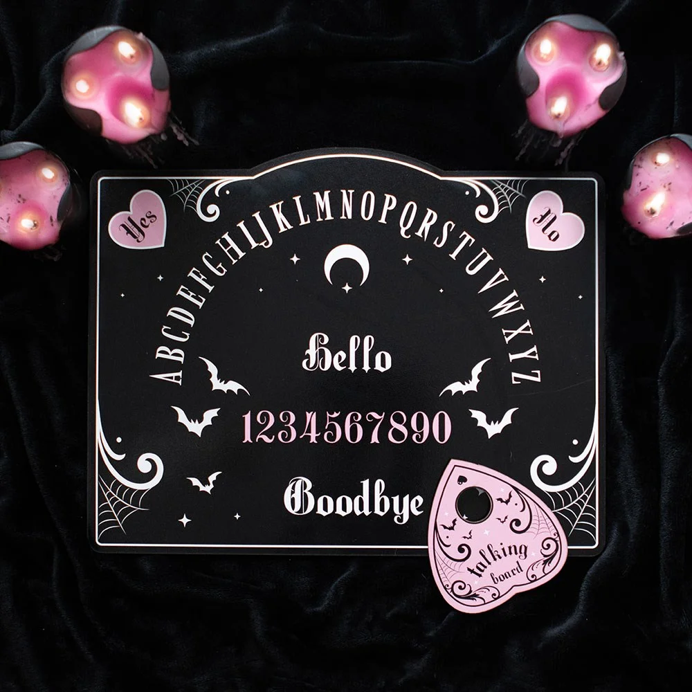 Pink and black talking board with bold, vibrant design for entertainment or decoration on a flat surface