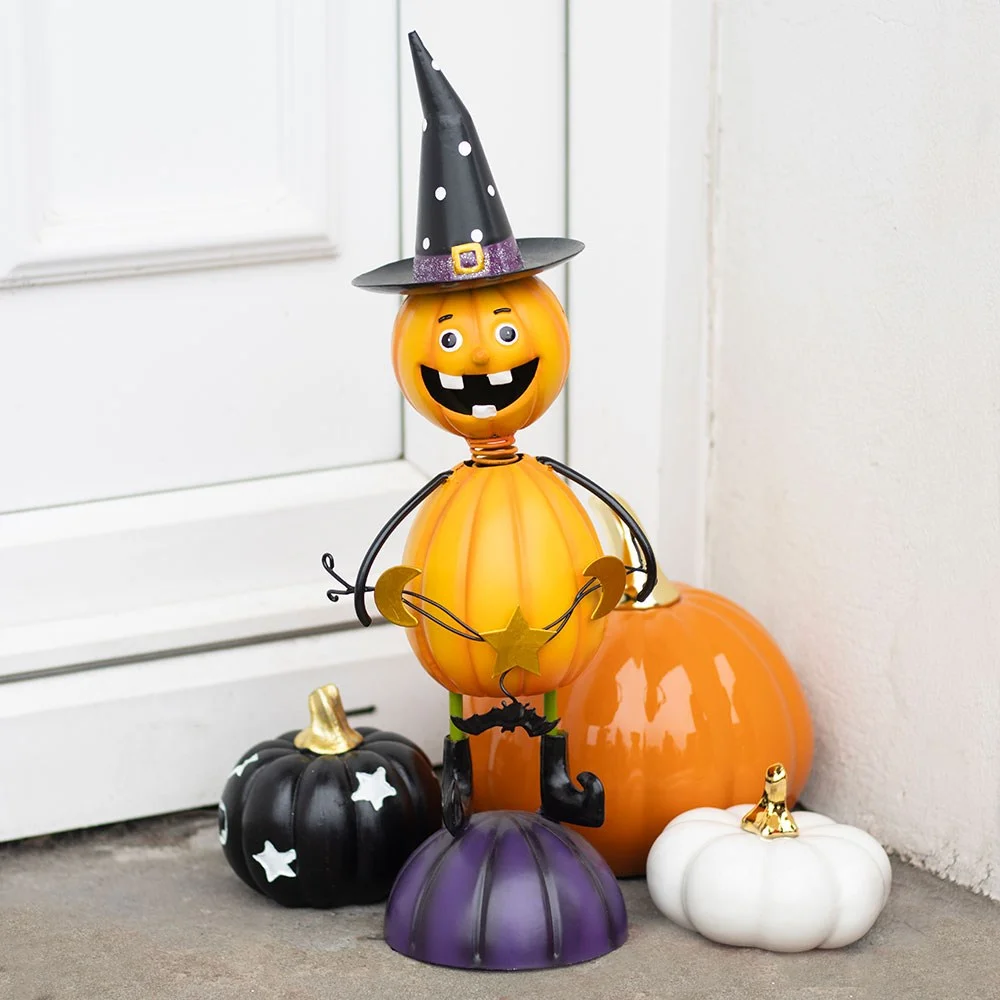 Orange metal pumpkin ornament with a smiling face wearing a black witch hat, rustic finish, Halloween decor accessory
