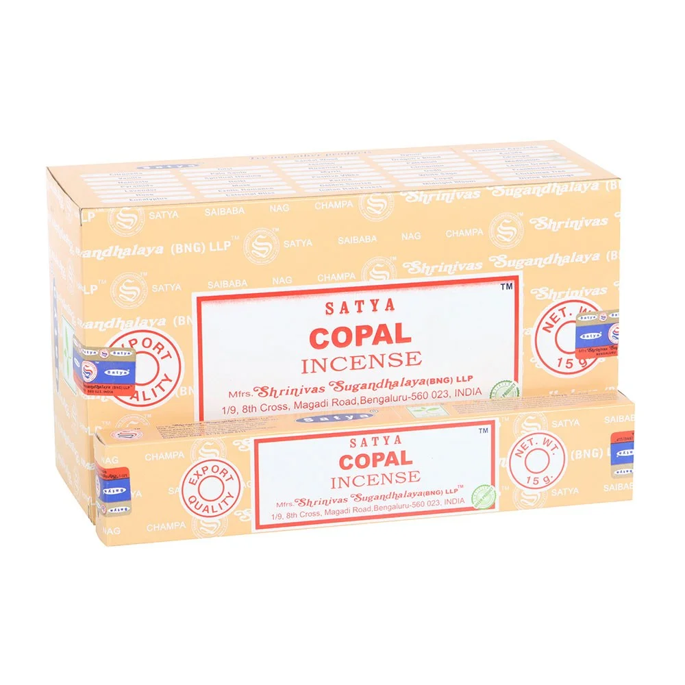Box of 12 Satya Copal incense sticks packs with colorful packaging stacked together on white background