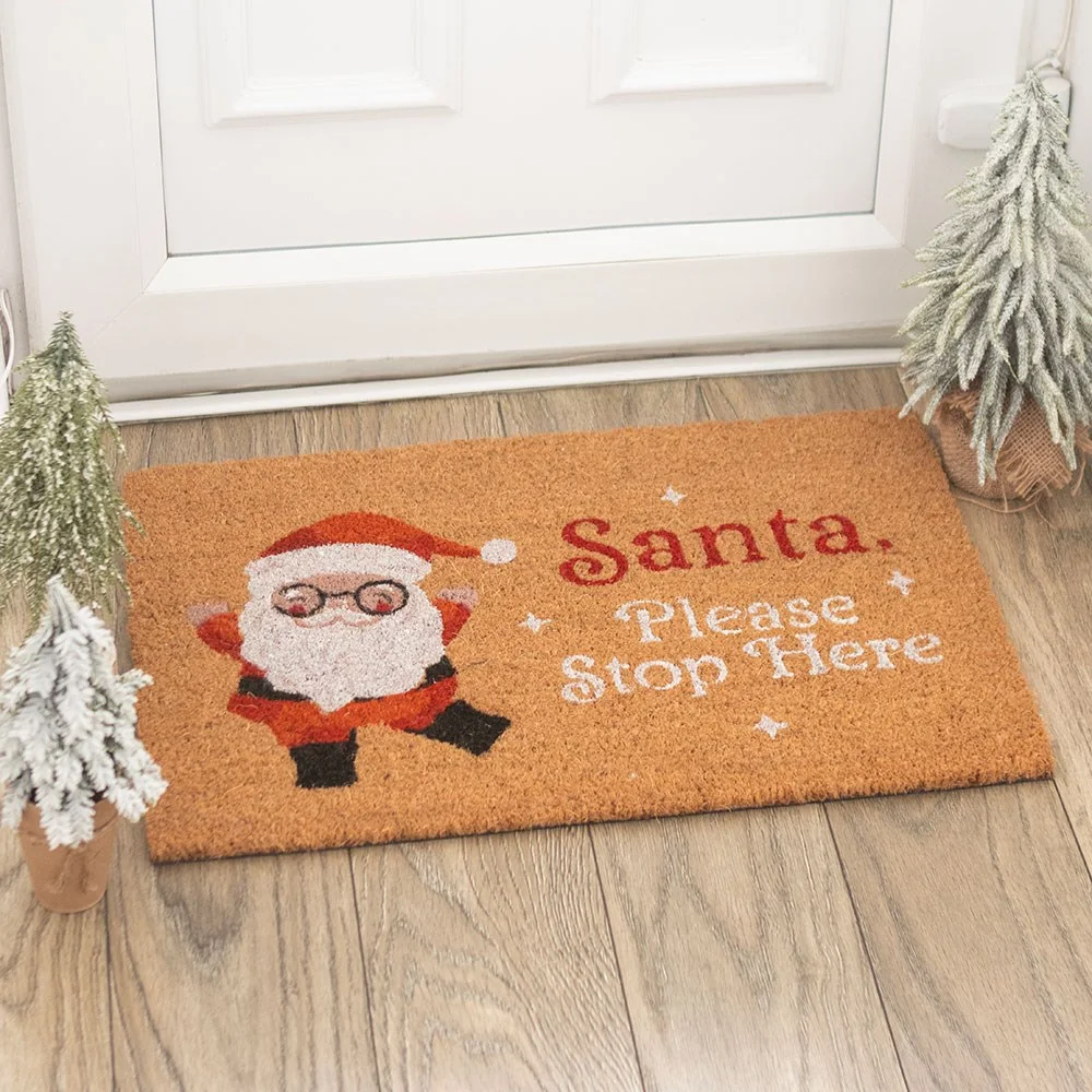 Santa Claus doormat with cartoon Santa and 'Santa Stop Here' text, welcoming holiday decor.