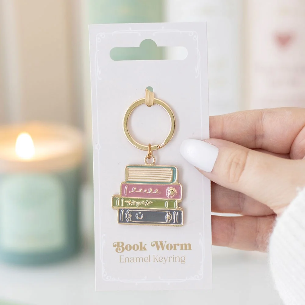 Book worm keyring featuring a metal worm reading a book, painted in vibrant enamel for bibliophiles