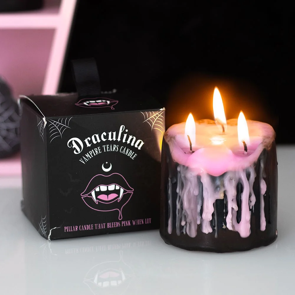 Small pink pillar candle with a gothic vibe, unscented wax that melts revealing pink drips for dramatic lighting.