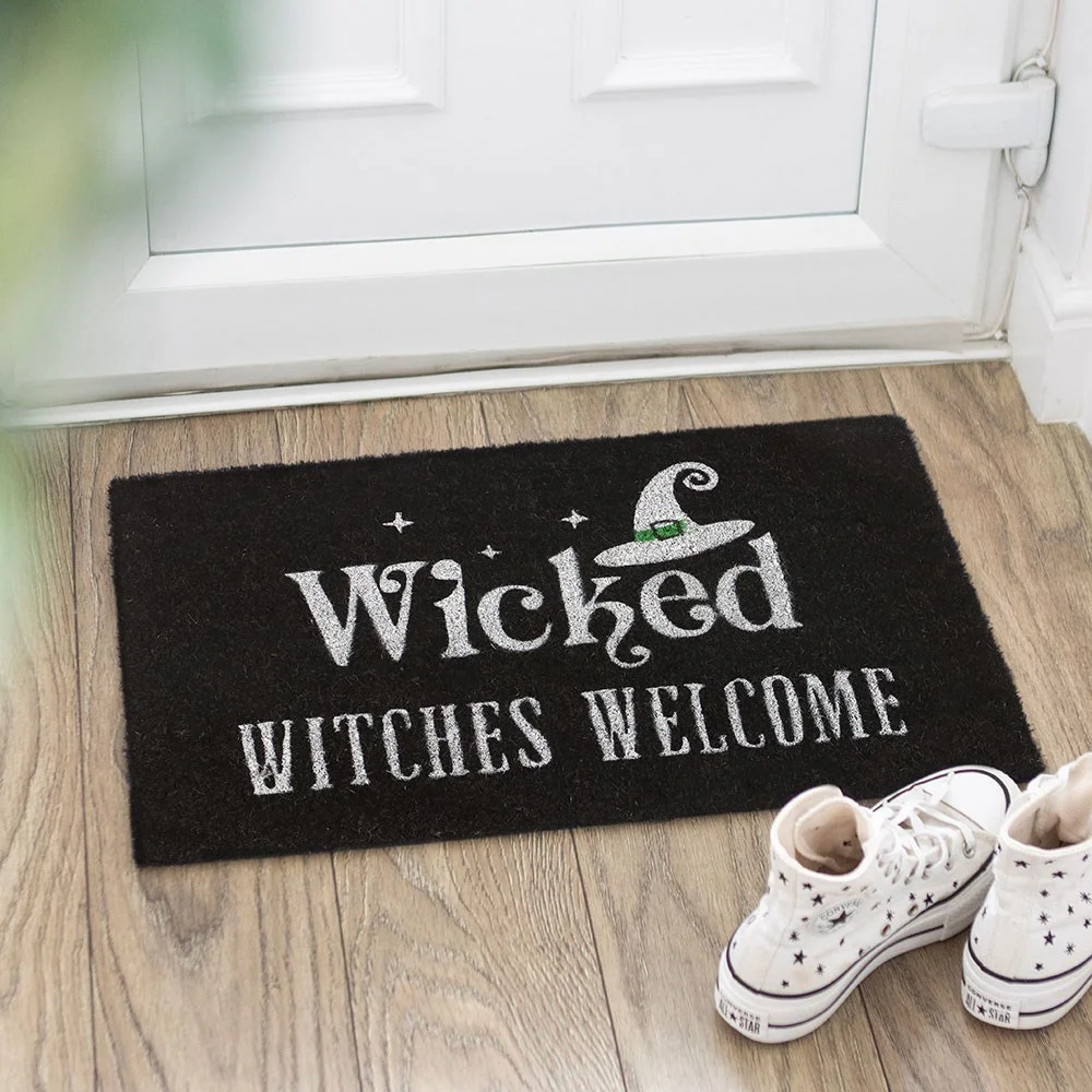 Black wicked witches doormat with bold text “Wicked Witches Welcome” and a witch hat graphic.