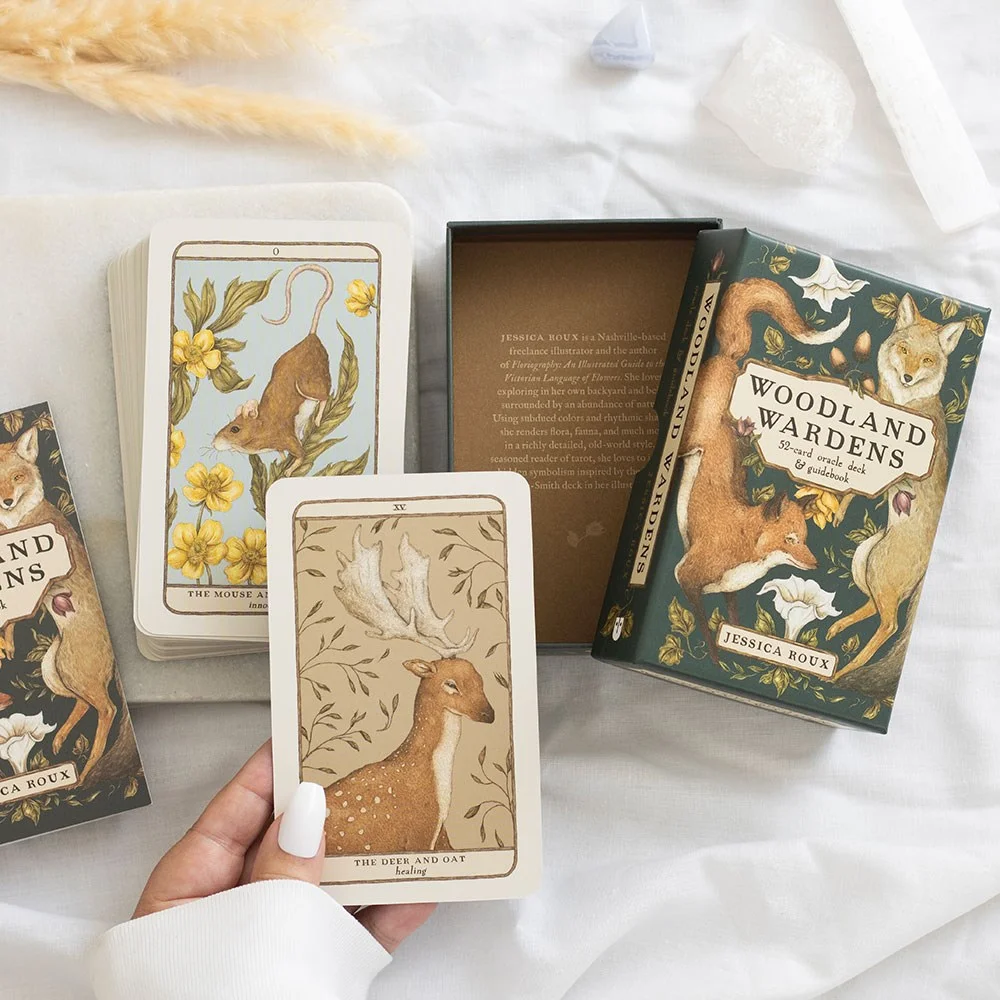 Woodland oracle cards and guidebook side-by-side, featuring elegant forest animal-plant illustrations