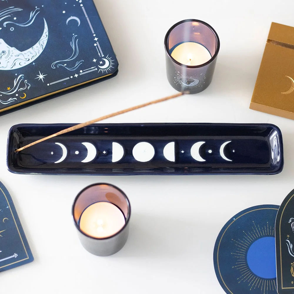 Ceramic incense ash catcher with blue moon phase design, catches ash during rituals in a simple, elegant shape.