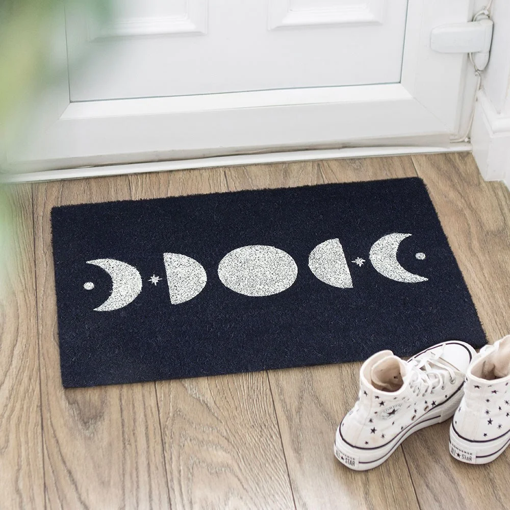 Moon phase doormat displaying lunar phases on a dark blue background, for a stylish celestial welcome indoors