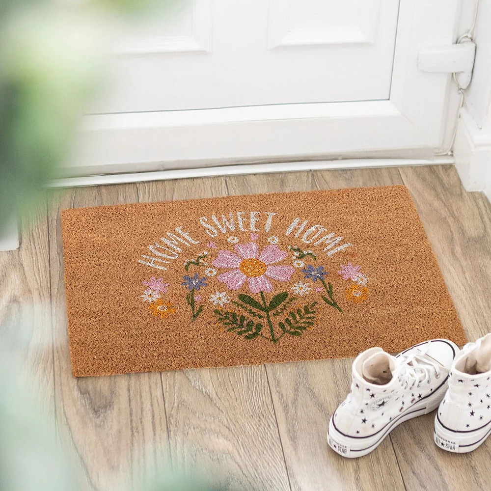 Colourful home sweet doormat with pink, purple and yellow daisy bouquet for a bright doorstep