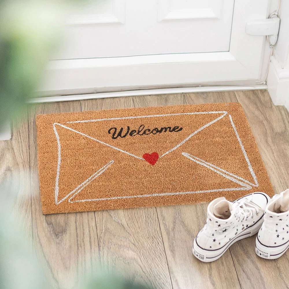 Valentine's Day doormat with love letter envelope graphic and bright red heart on doorstep.