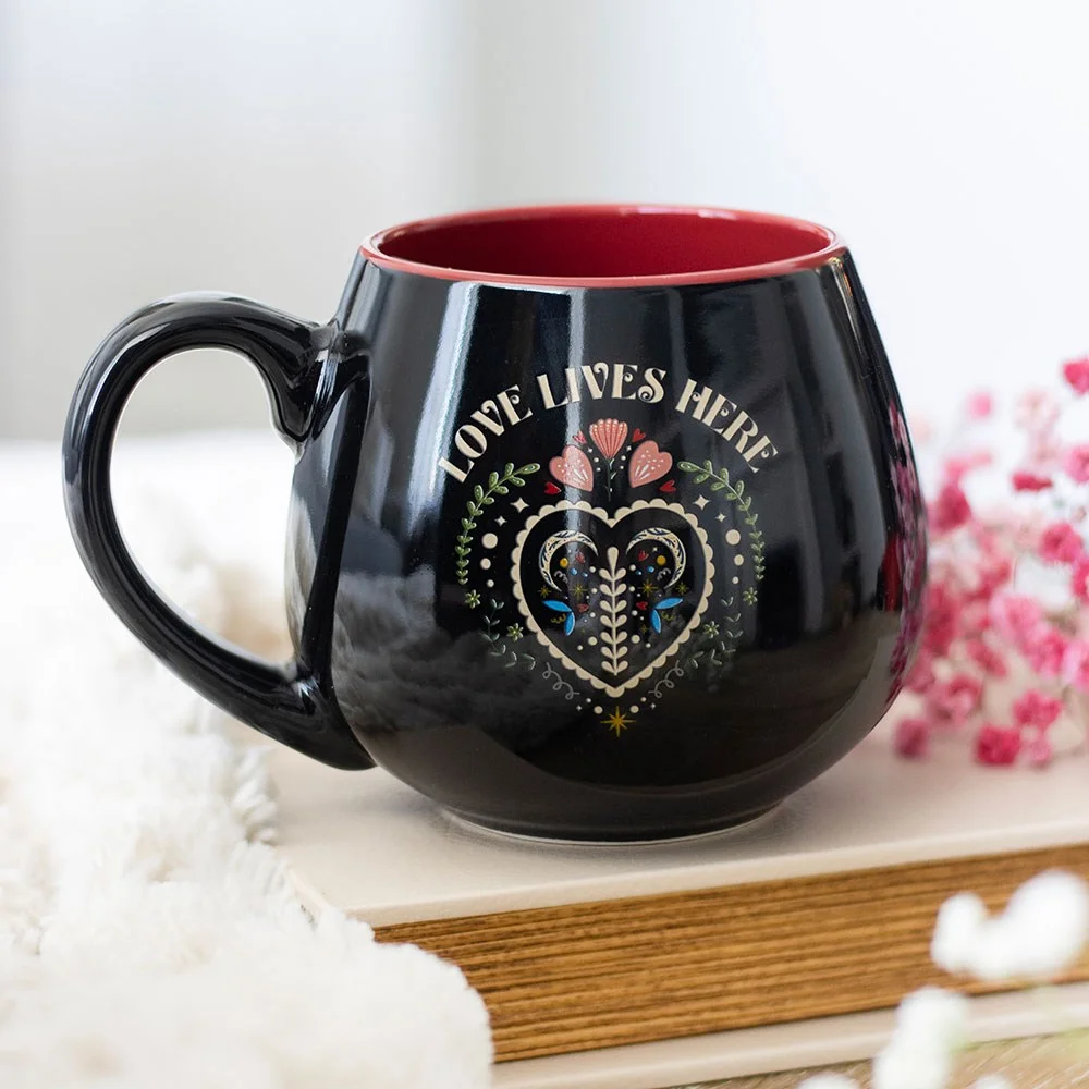 Black rounded ceramic folk heart mug with Love Lives Here design, 500ml, microwave and dishwasher safe