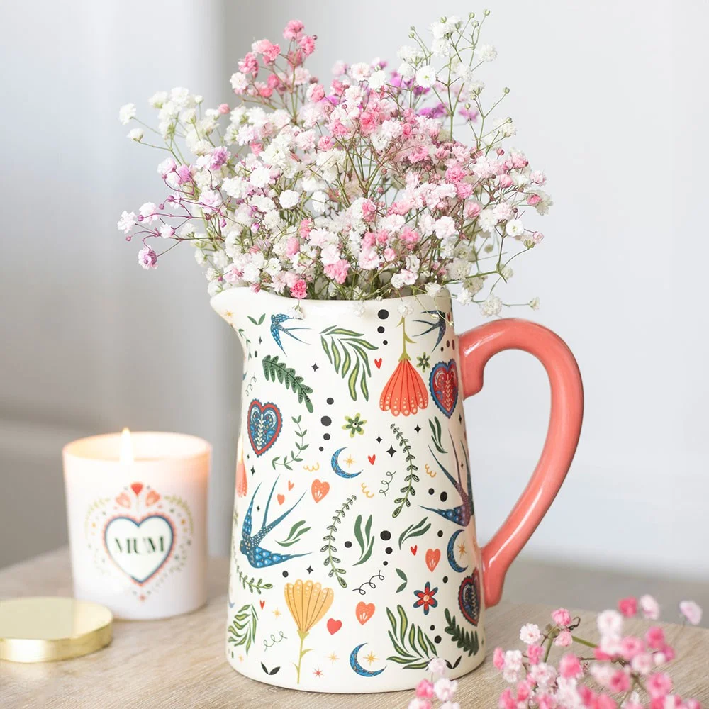 Cream ceramic flower jug with folk floral pattern, ideal for fresh or dried flowers in rustic decor settings