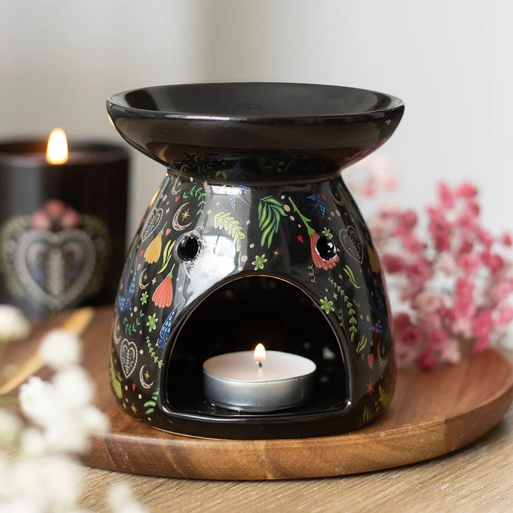 Black ceramic oil burner with Midnight Bloom floral print and a bowl for fragrance oil or wax melts on top