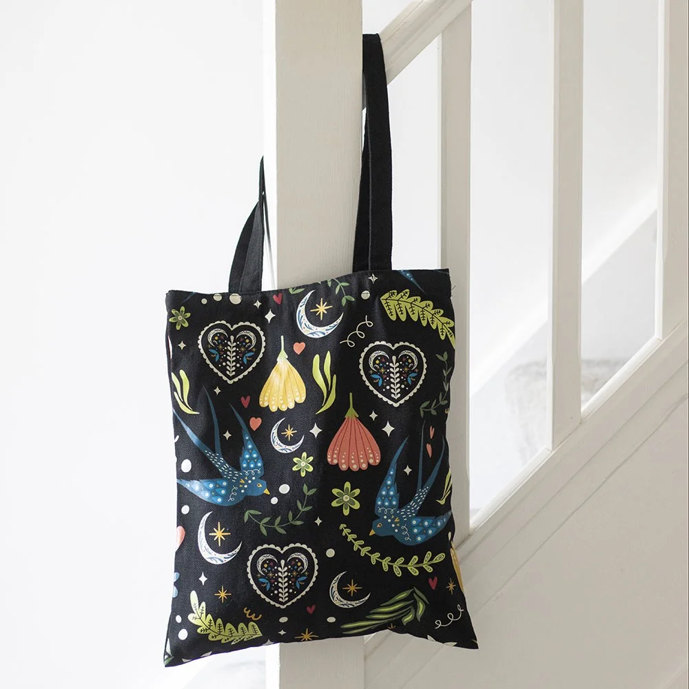 Black polycotton tote bag with white and grey Midnight Bloom floral print, flat on white background