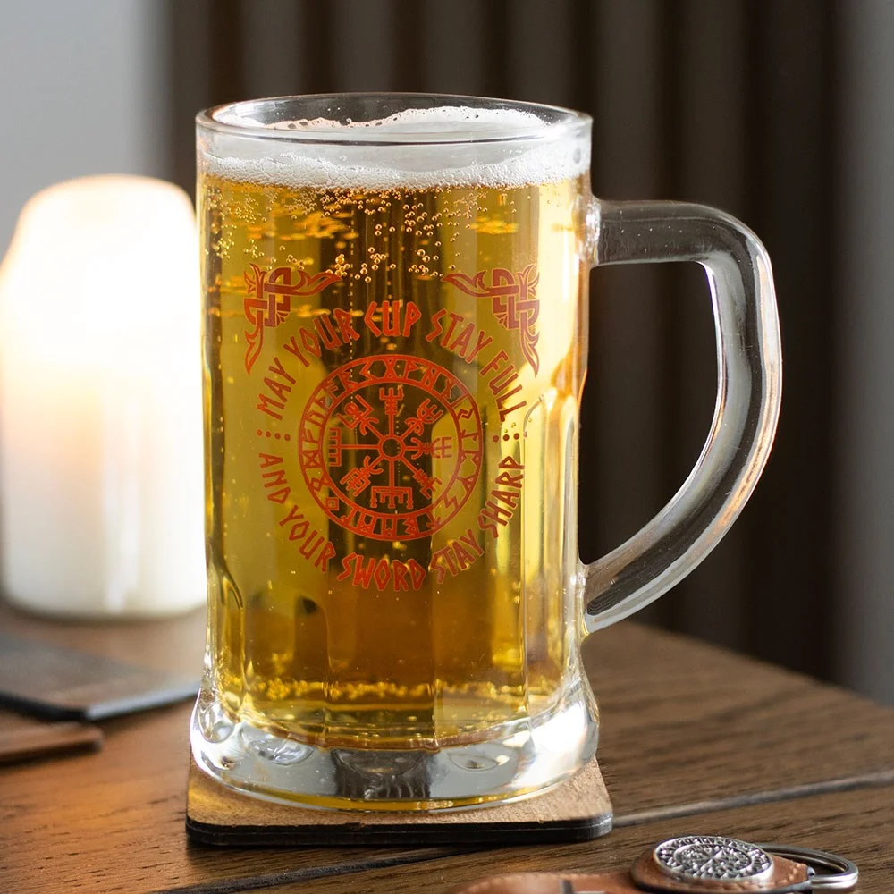 Viking glass beer tankard with Vegvisir compass design and matching cork coaster on white background