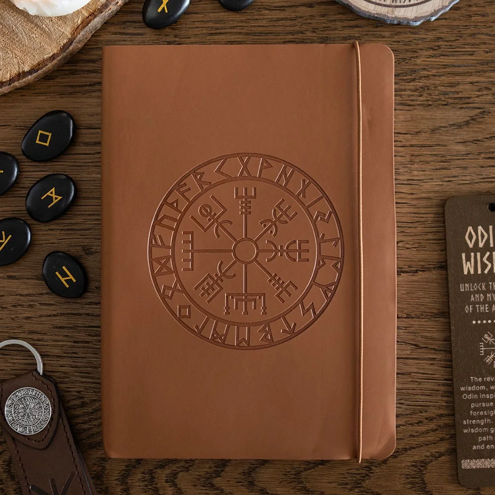 A5 faux leather Viking compass journal embossed with Vegvisir compass, shown with matching pen on white background