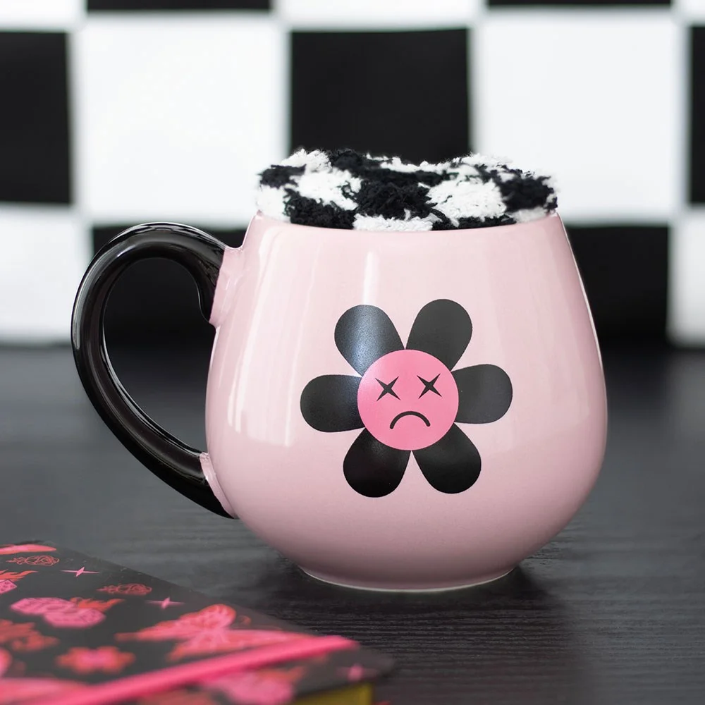 Black and pink sad flower mug set with 500ml capacity alongside soft black and white checkerboard socks on white background