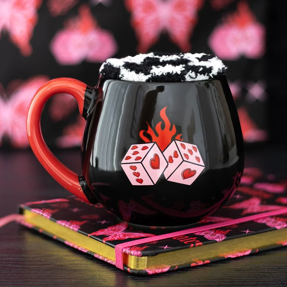 Black dice mug set with flaming dice design and black-and-white checkerboard socks on a white background